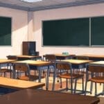 Un moderno salón de clases con computadoras y una pizarra digital.