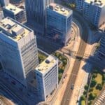 Vista aérea de un centro empresarial moderno con edificios tecnológicos y trenes en movimiento.